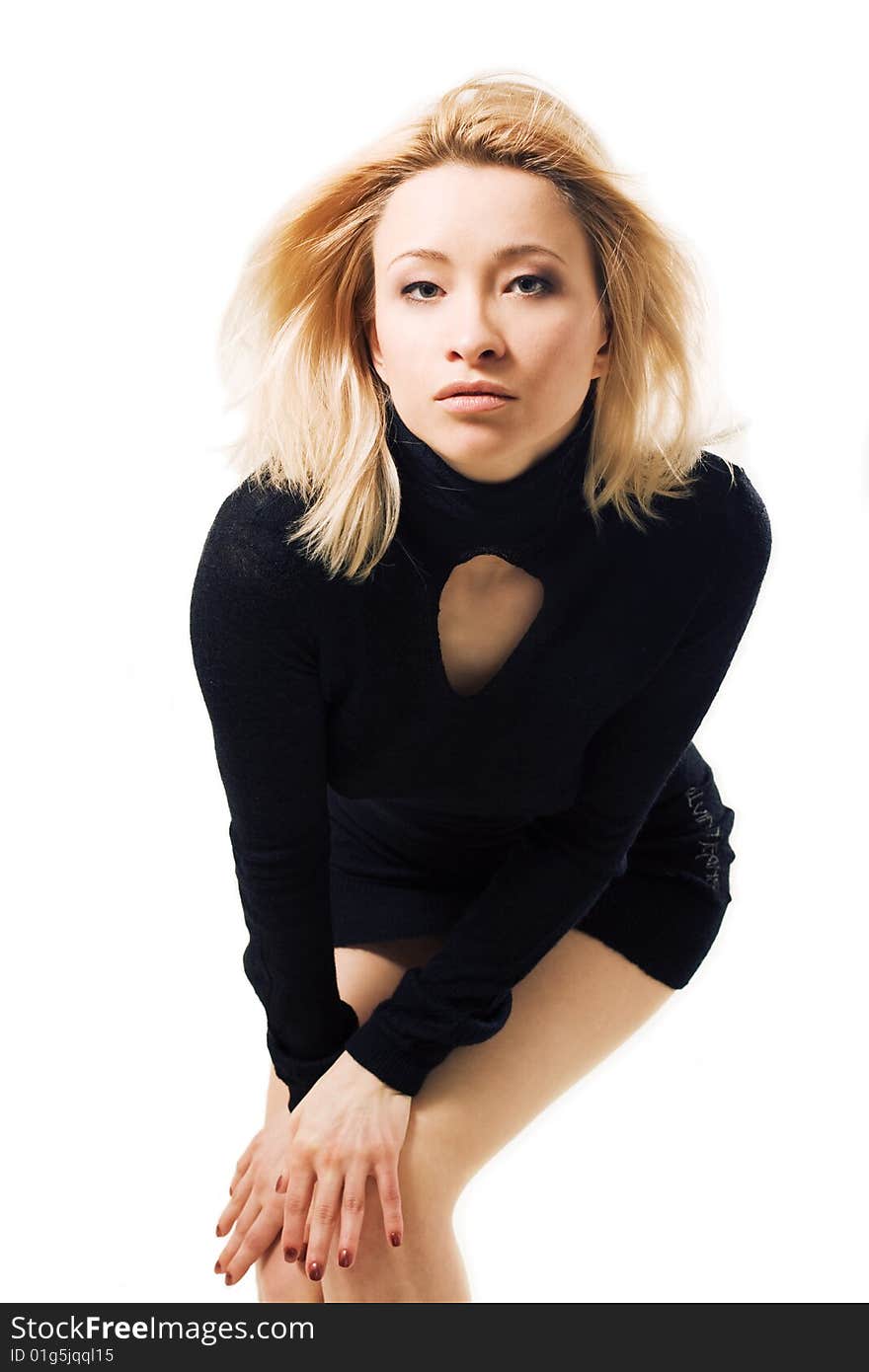 Blond woman wearing little black dress on white background