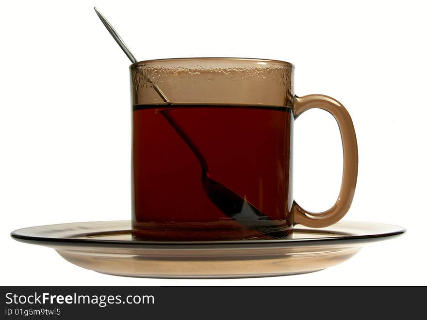 Glass cup of tea with spoon isolated on white