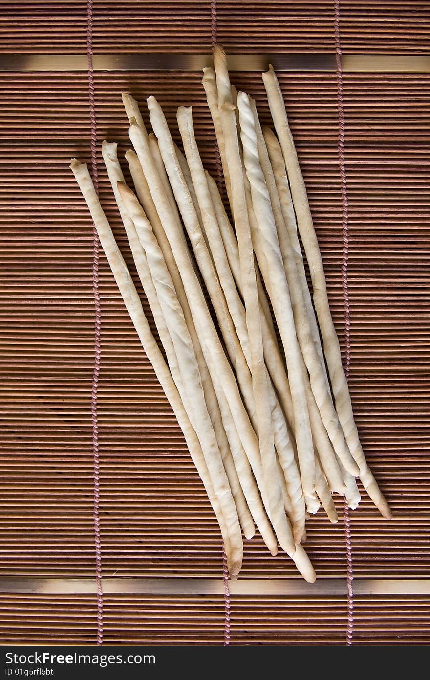 Bread sticks on a bamboo pad