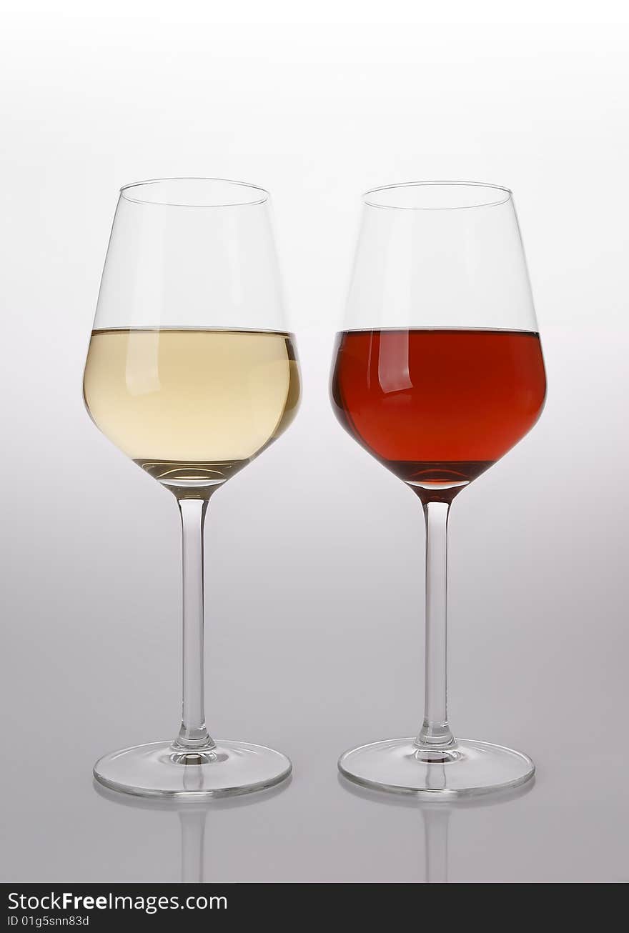 Glasses of red and white wine with reflection. Glasses of red and white wine with reflection