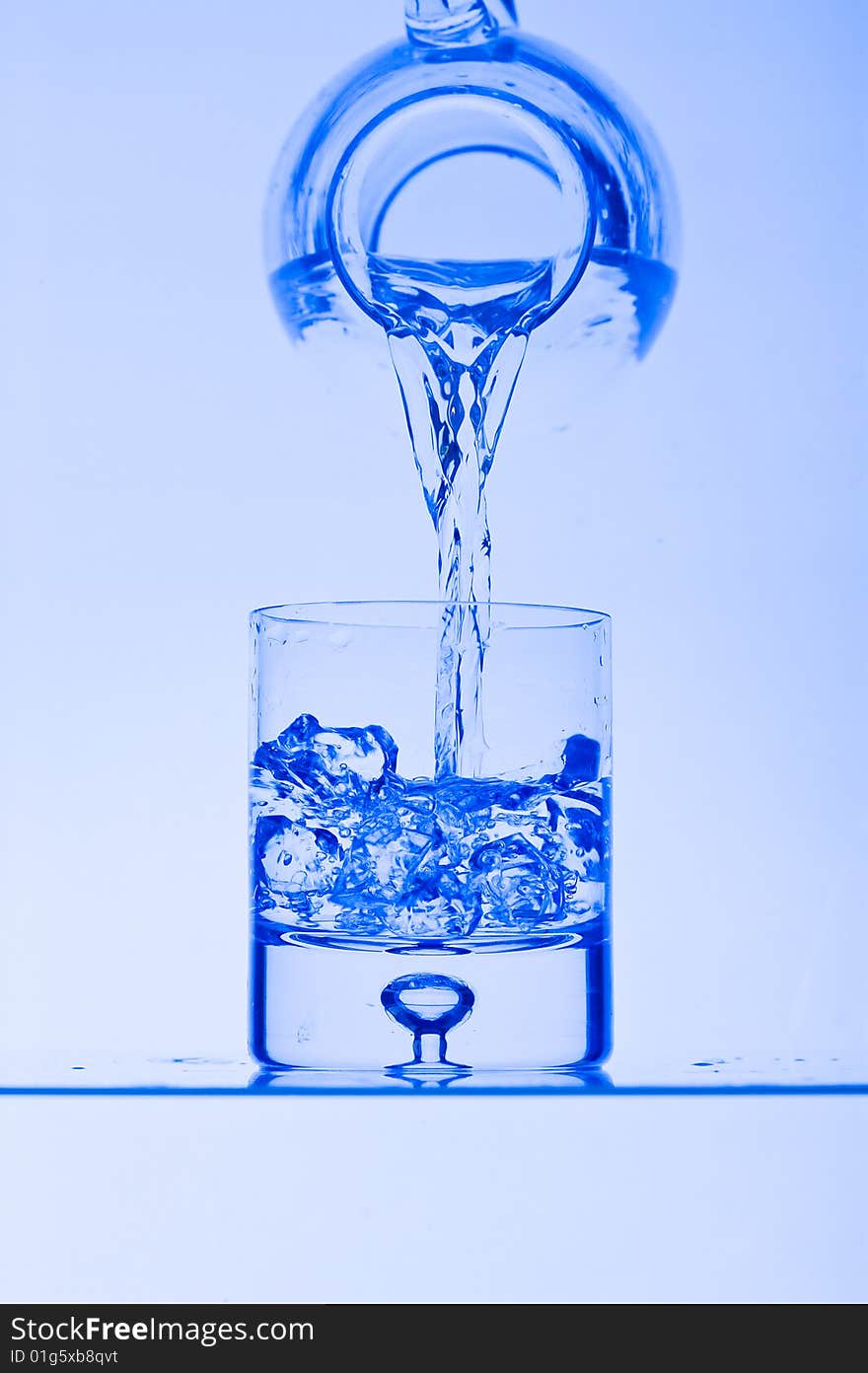 Blue Glass with Splashing water. Coolness Drink. Blue Glass with Splashing water. Coolness Drink