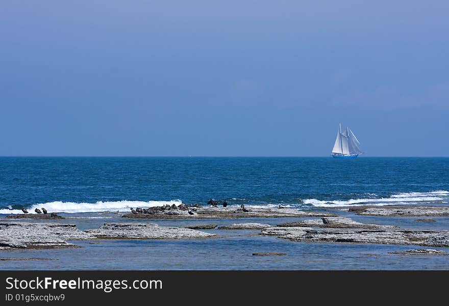 View from a shoreline called Neptuni Fields with ship in the background.