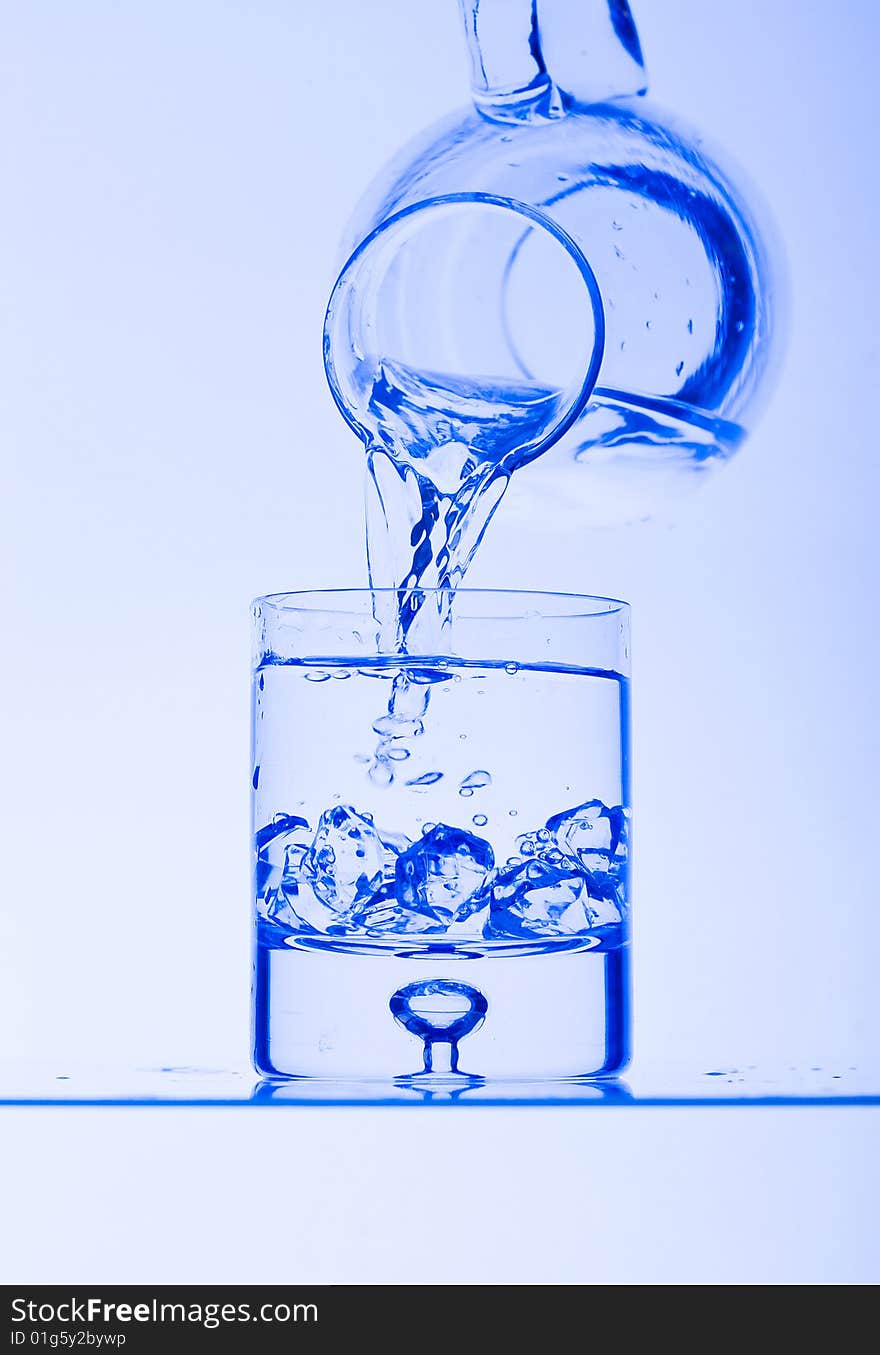 Blue Glass with Splashing water. Coolness Drink. Blue Glass with Splashing water. Coolness Drink