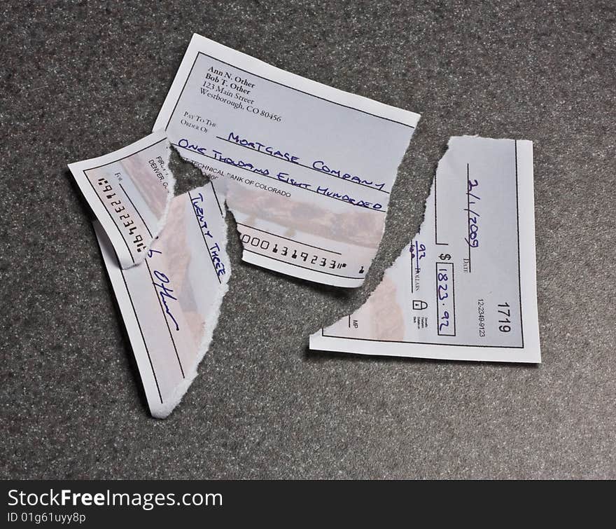 A mortgage payment check torn into pieces. The check is entirely original artwork and the routing number is deliberately too short. A mortgage payment check torn into pieces. The check is entirely original artwork and the routing number is deliberately too short.