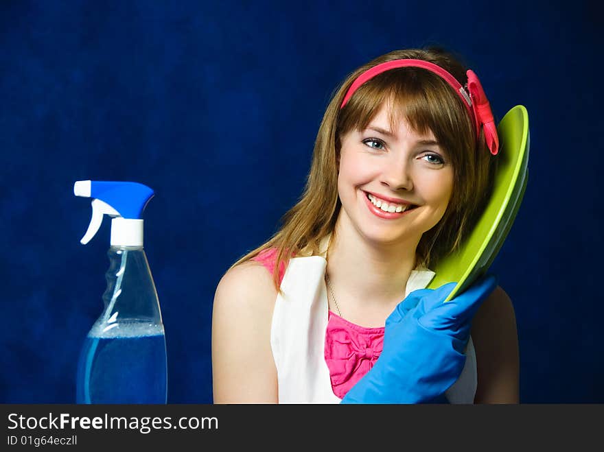 Portrait of a beautiful cheerful young housewife washing the dishes