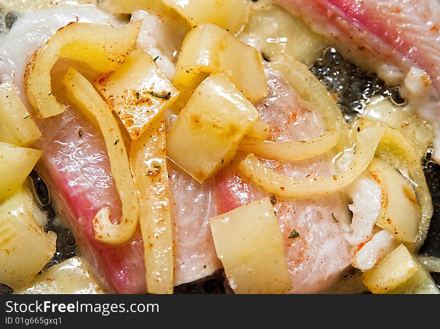 Pangasius filet frying with yellow peppers. Pangasius filet frying with yellow peppers