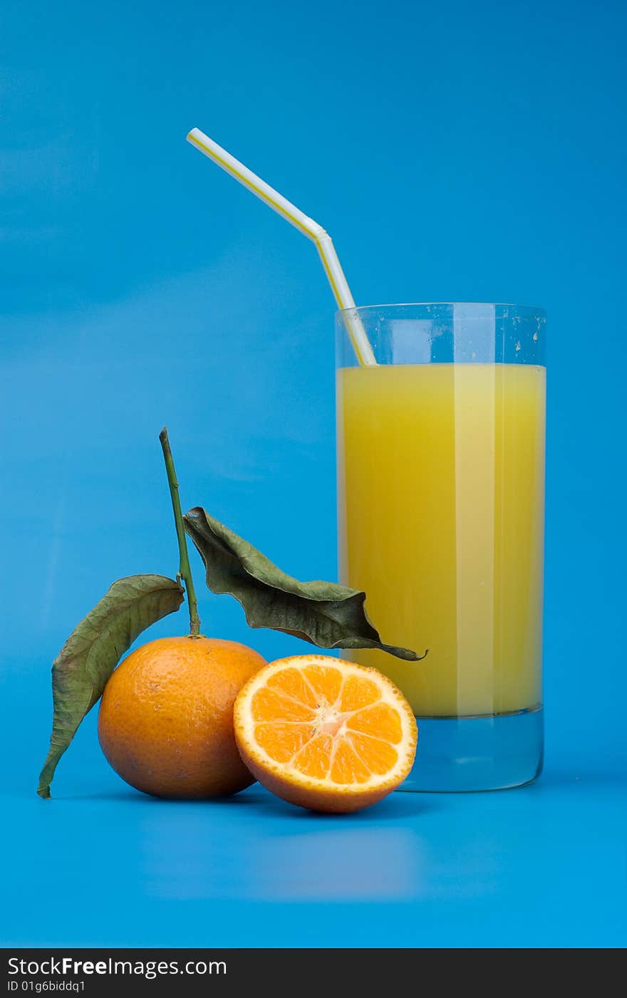 Tangerines and juice on a dark blue background