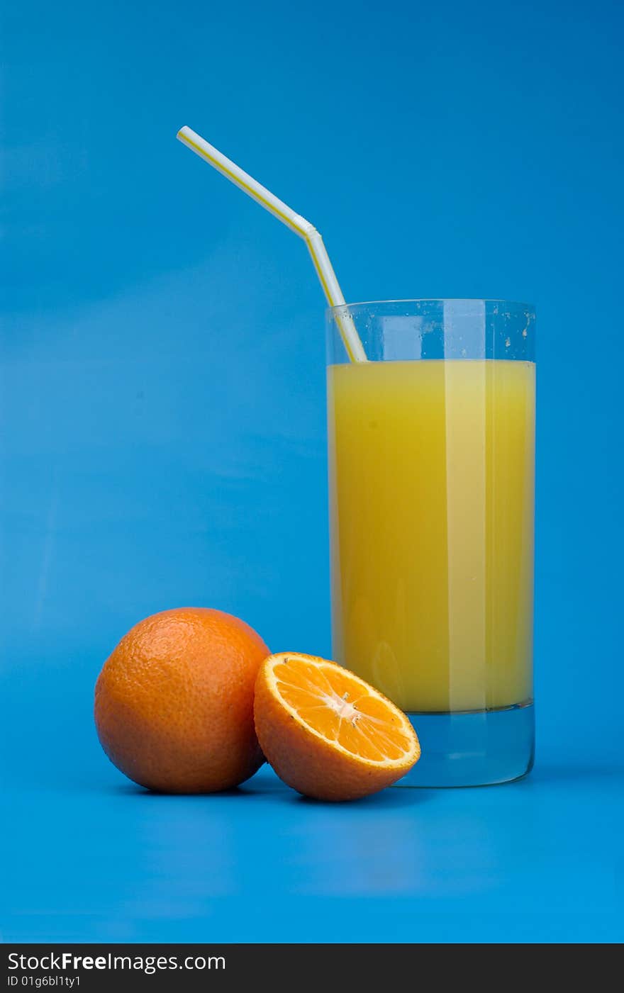 Tangerines and juice on a dark blue background