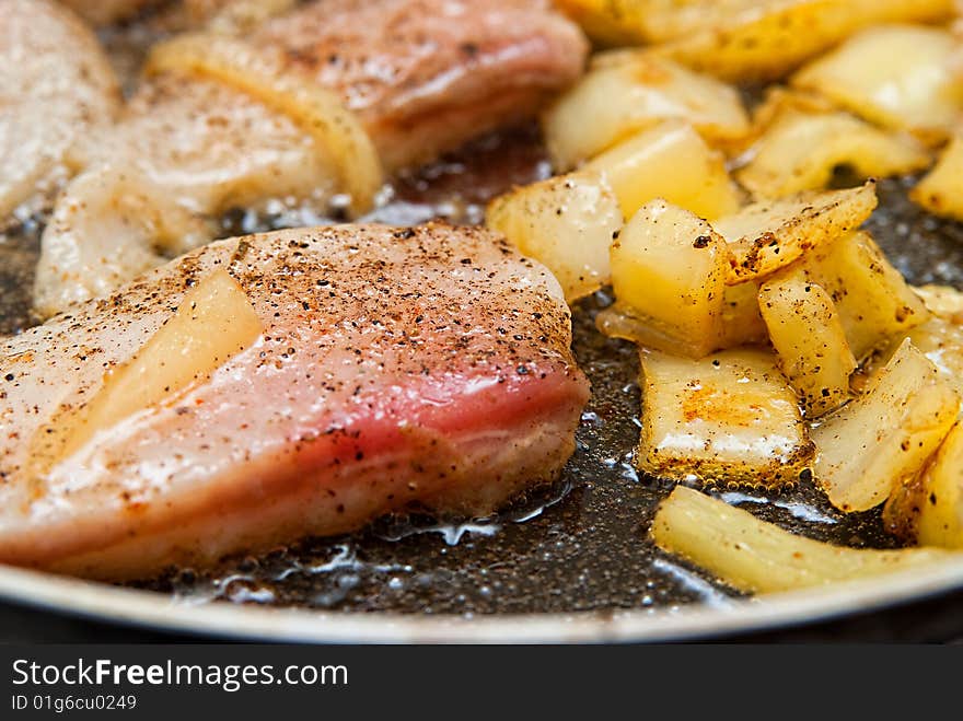 Pangasius filet frying with yellow peppers. Pangasius filet frying with yellow peppers