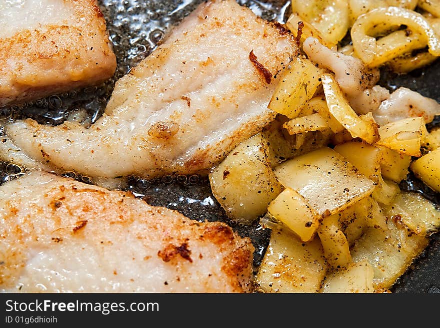 Pangasius filet frying with yellow peppers. Pangasius filet frying with yellow peppers