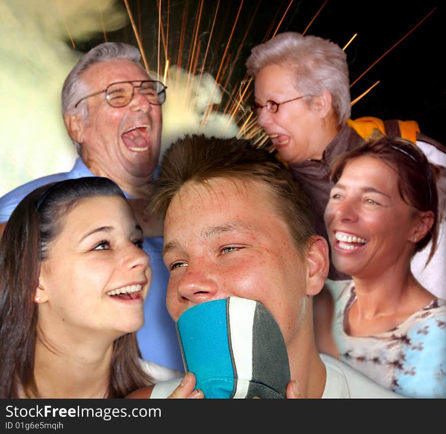 Family celebrating a Holliday with a teenaged boy in the foreground and fireworks in the background. Family celebrating a Holliday with a teenaged boy in the foreground and fireworks in the background