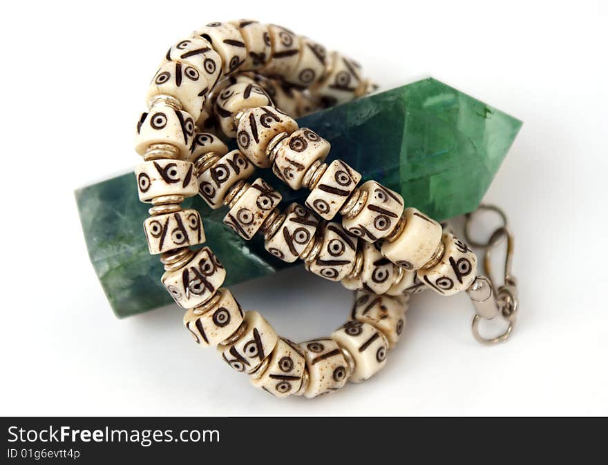 Bracelet is swathed around stone. Bracelet is swathed around stone