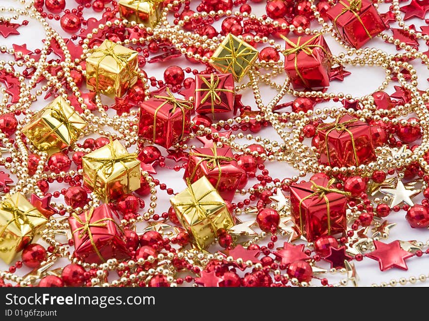 Beautiful holiday background with golden and red boxes and beads