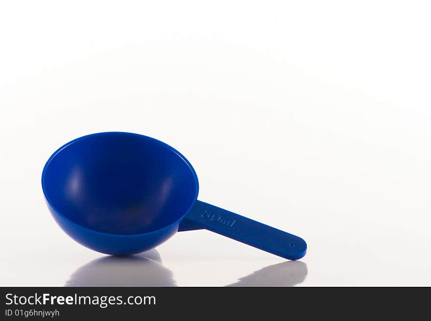 Image of a blue plastic measuring spoon showing a 50ml capacity. Image of a blue plastic measuring spoon showing a 50ml capacity