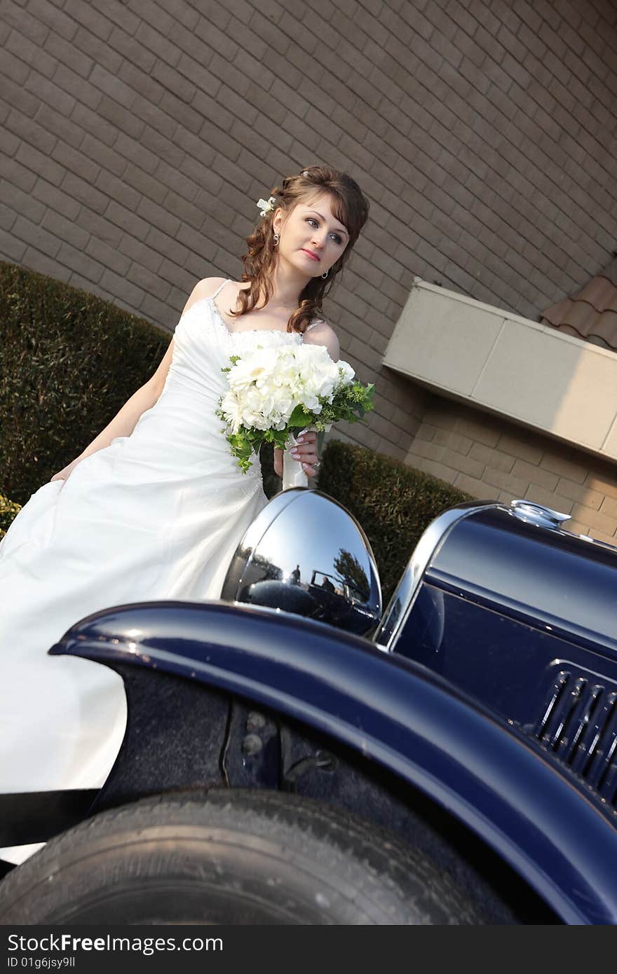 Portrait of bride behind a retro car. Portrait of bride behind a retro car