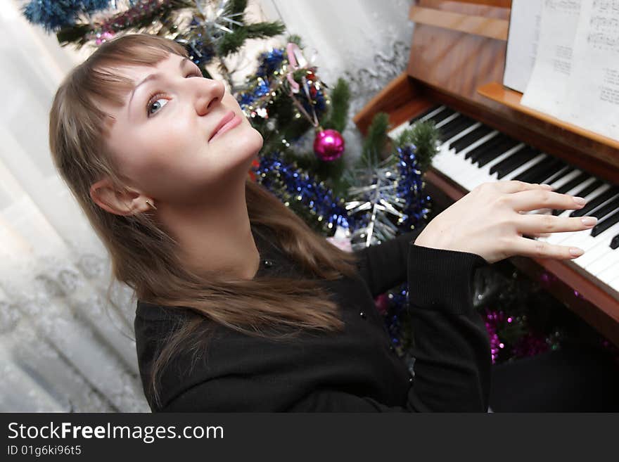 The girl plays the piano at home. The girl plays the piano at home