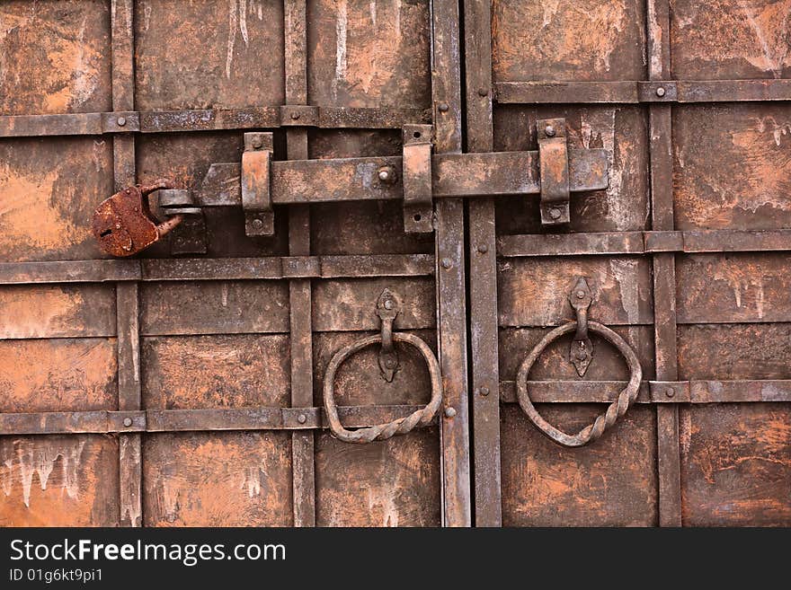 Old metel gate with rusted lock and handles. Old metel gate with rusted lock and handles