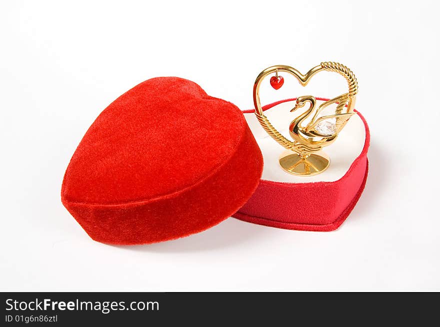 Heart shaped red gift box with lovely statuette, isolated on white. Heart shaped red gift box with lovely statuette, isolated on white