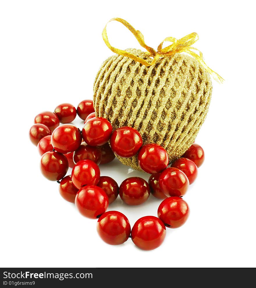 Wooden beads and golden straw heart isolated on a white background