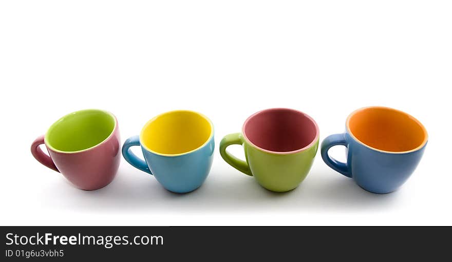 Colored cups aligned on white background