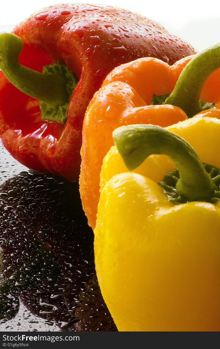 Three Bell Peppers on Wet Surface