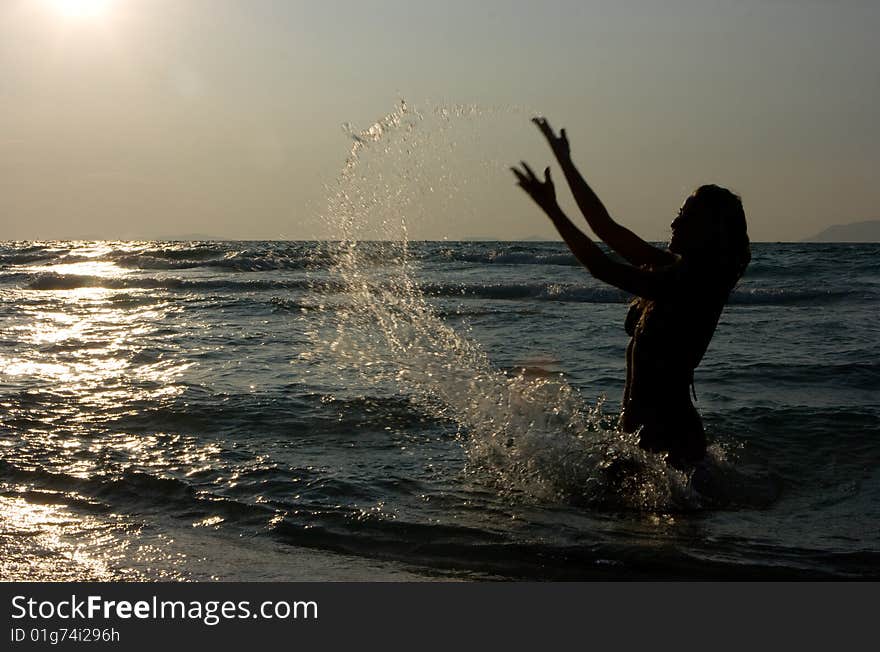 Girl making splashes in the sea