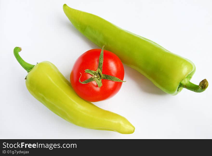 Isolated peppers and tomato on white background. Isolated peppers and tomato on white background