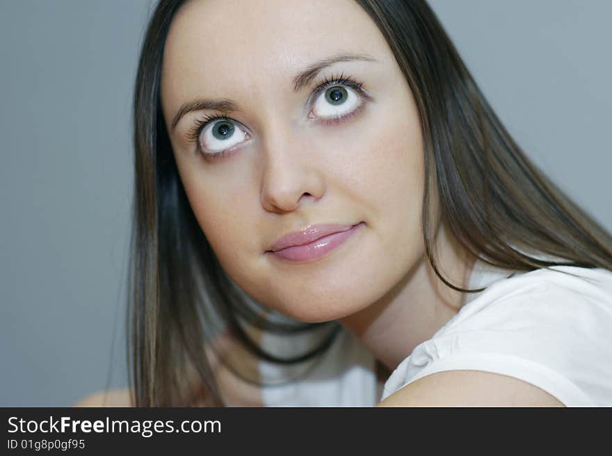 Woman with big eyes on grey background