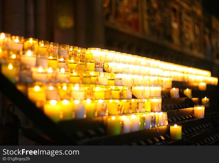 Votive candles lit inside cathedral