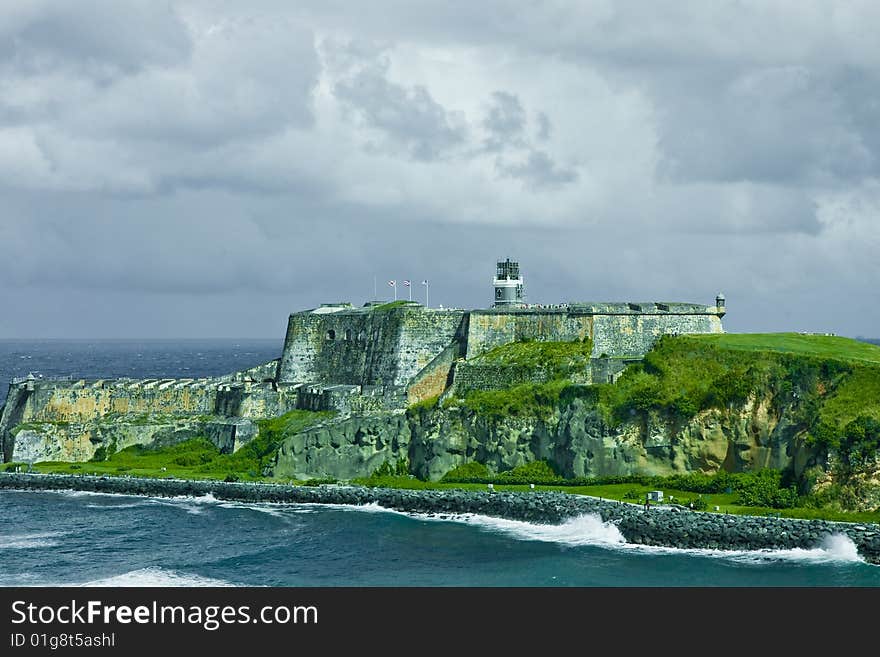 Fort On Green Cliffs Under Clouds