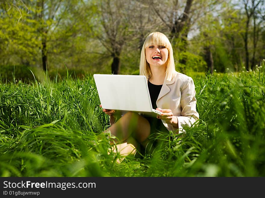 Laughing girl with laptop outdoors. Laughing girl with laptop outdoors