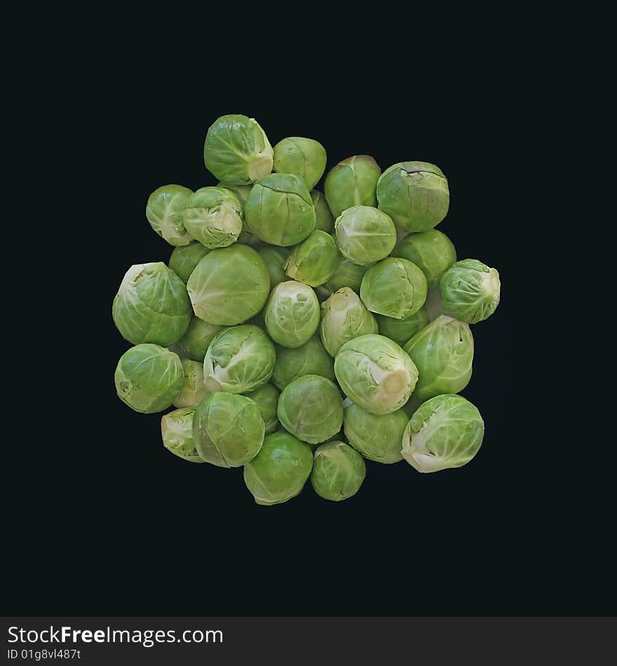 Fresh, raw, green brussels sprouts on black background