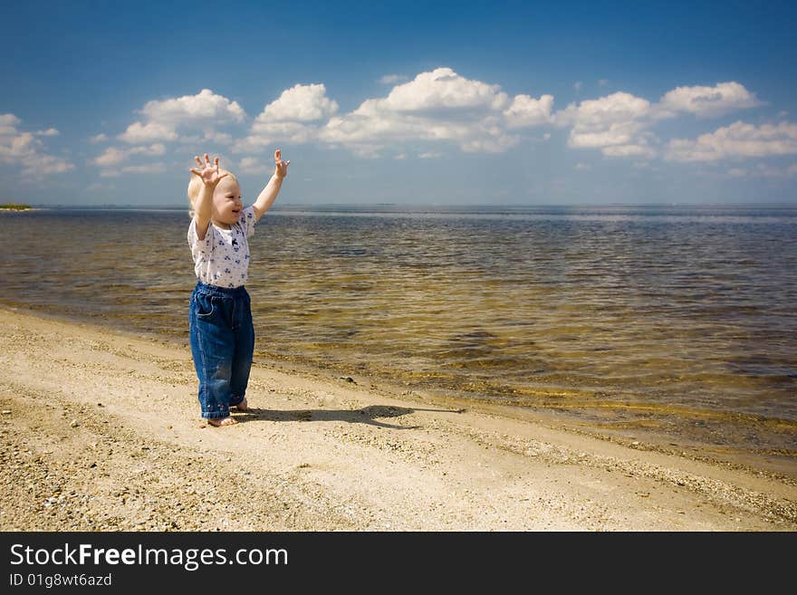 Barefoot child is happy on the river bank. Barefoot child is happy on the river bank