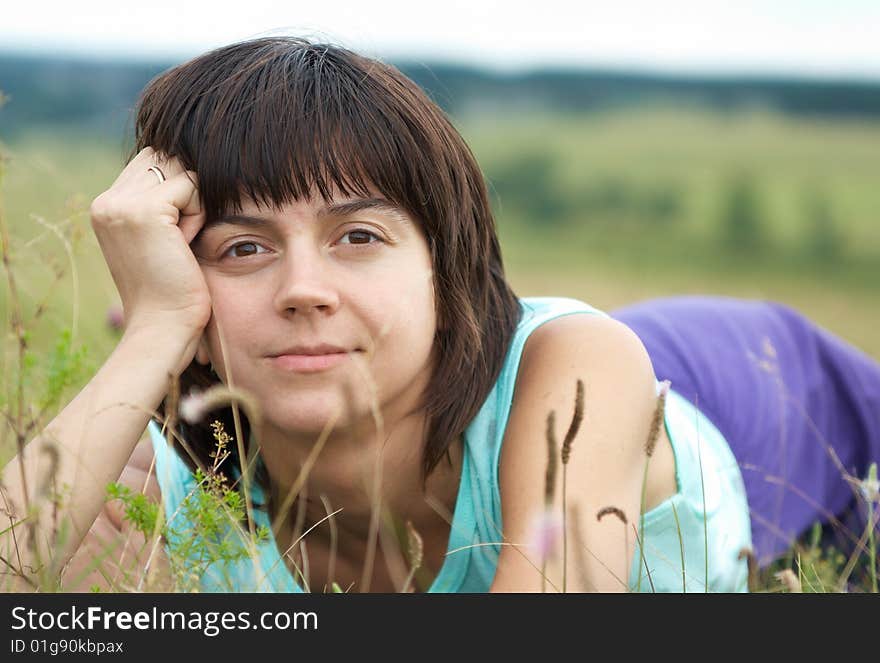 Young woman on the green grass