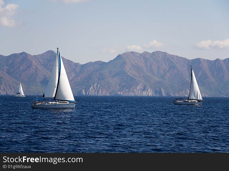 Sailboat at sea on a background mountains. Sailboat at sea on a background mountains