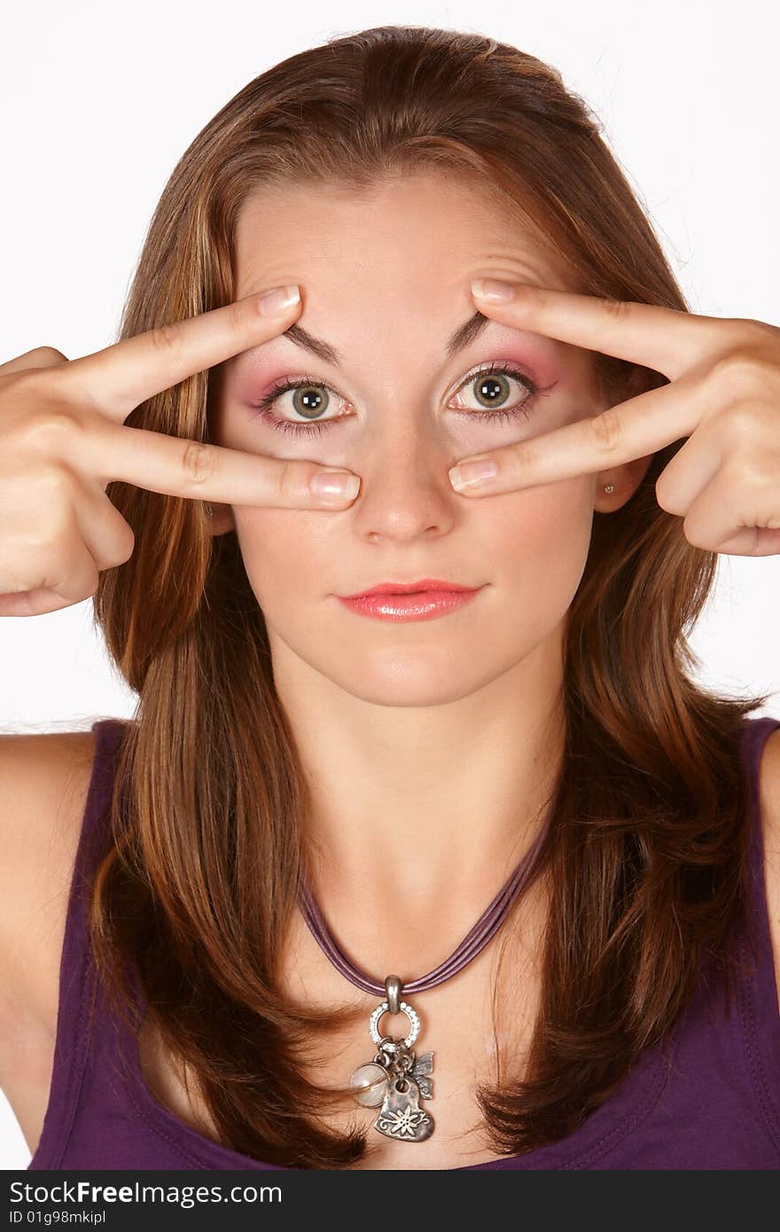 Brunette trying to keep awake by opening eyes with fingers. Brunette trying to keep awake by opening eyes with fingers