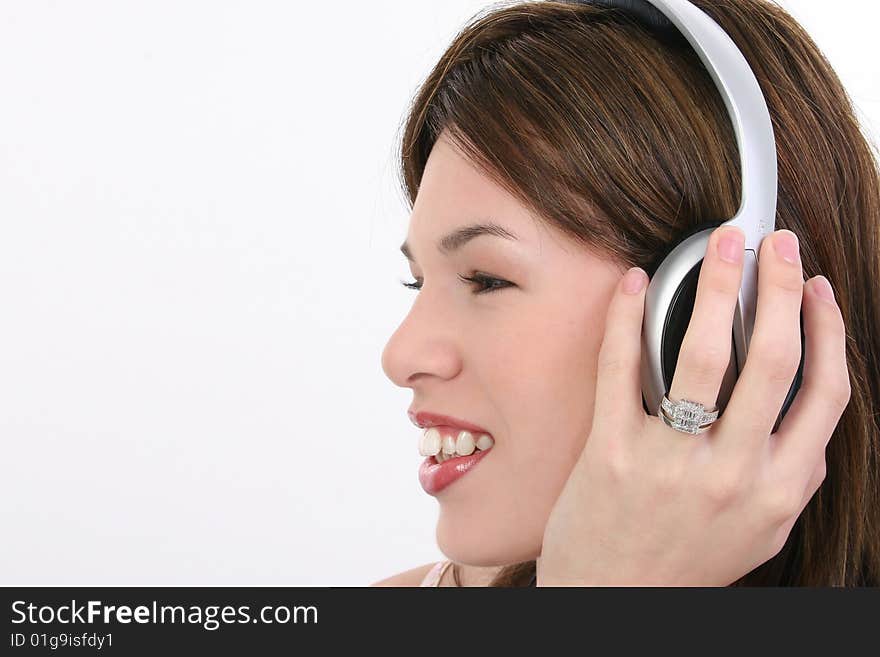 Beautiful Hispanic woman listening to audio over headphones. Beautiful Hispanic woman listening to audio over headphones.