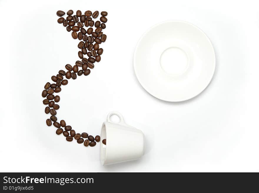 White cup, saucer and beans coffee on a white background