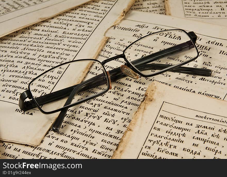 Glasses on the  old book pages