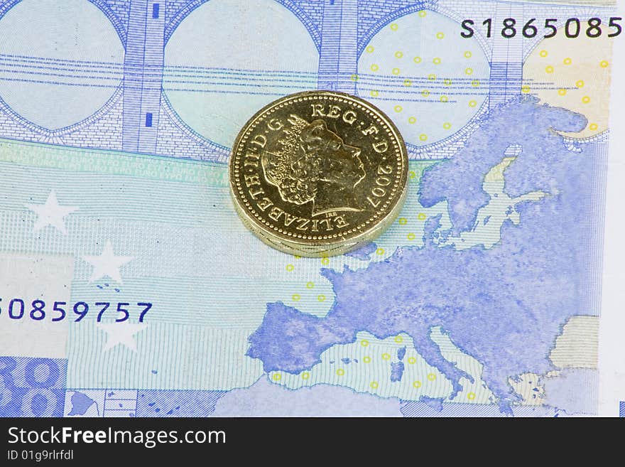 British pound coin on a twenty euro note showing the map of europe. British pound coin on a twenty euro note showing the map of europe