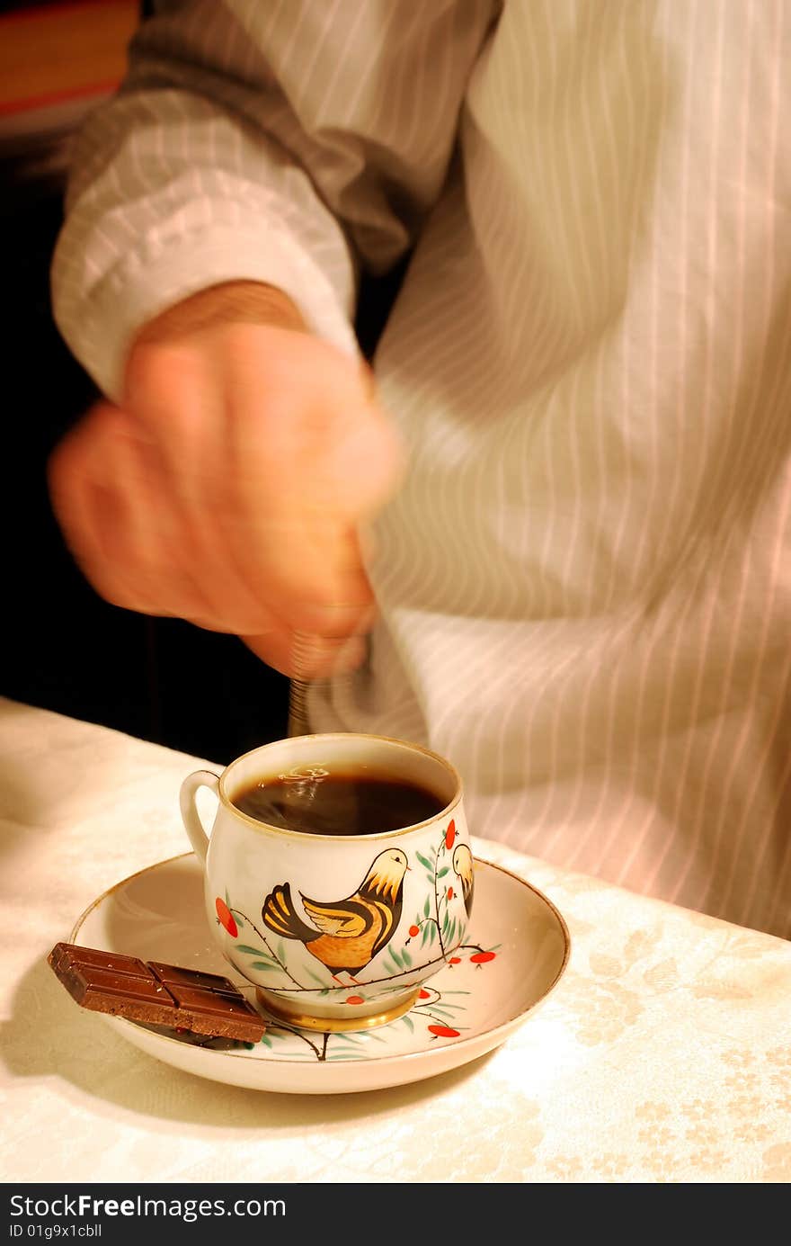 A hand mixing sugar in a cup of coffee  in motion (flash in a rear mode) 
:-). A hand mixing sugar in a cup of coffee  in motion (flash in a rear mode) 
:-)