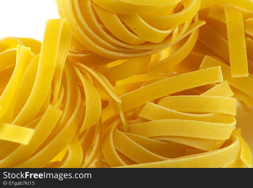 Tagliatelle pasta isolated on white background close up