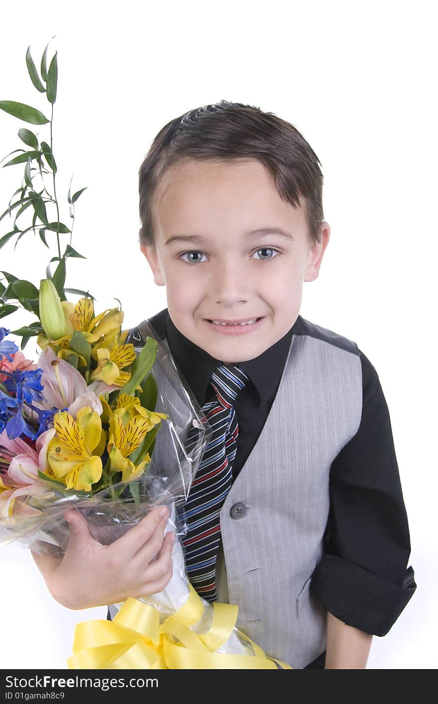 Image of small boy in suit presenting flowers as a gift. Image of small boy in suit presenting flowers as a gift