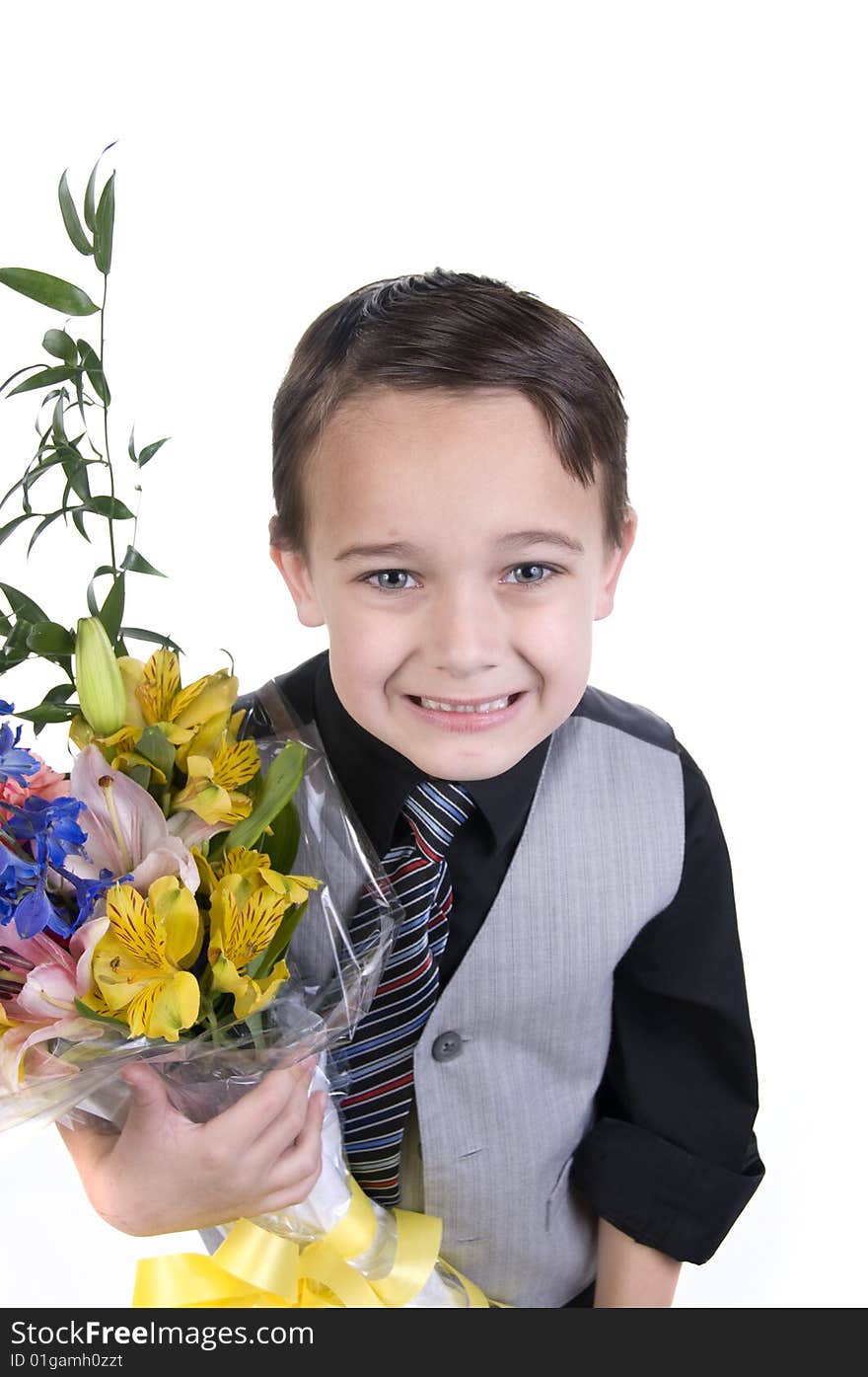 Image of small boy in suit presenting flowers as a gift. Image of small boy in suit presenting flowers as a gift