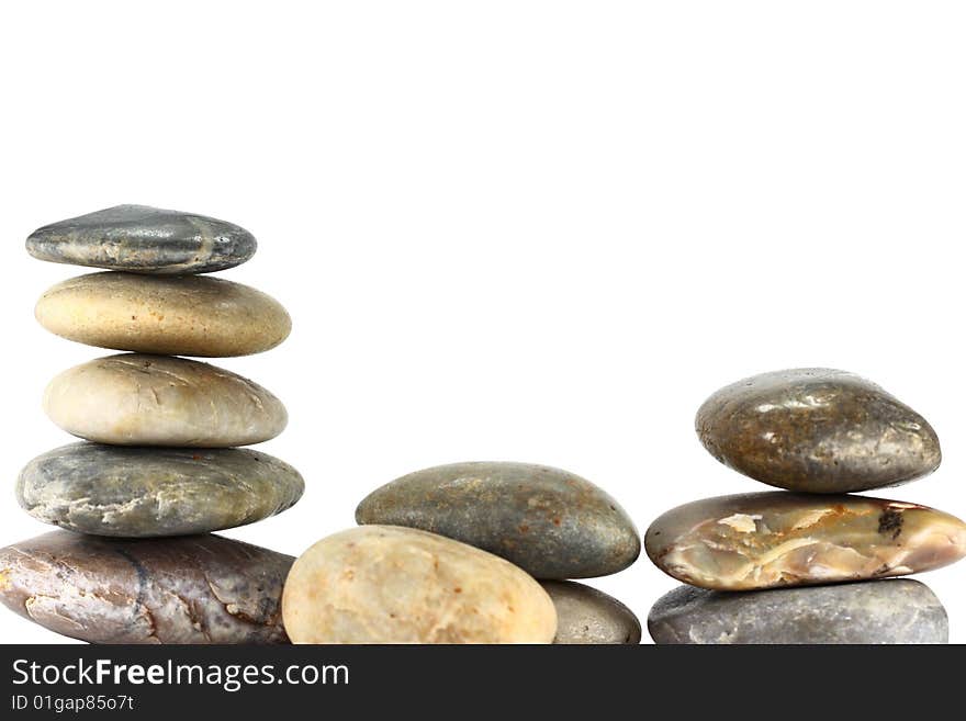 A selection of rocks balancing on a white background. A selection of rocks balancing on a white background