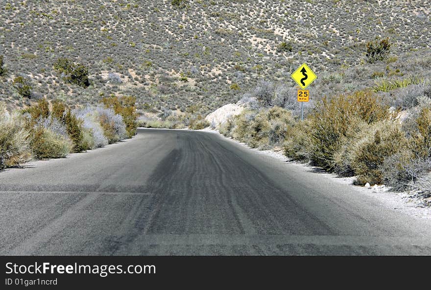 A Lone Stretch of Highway Winding Through the Desert. A Lone Stretch of Highway Winding Through the Desert