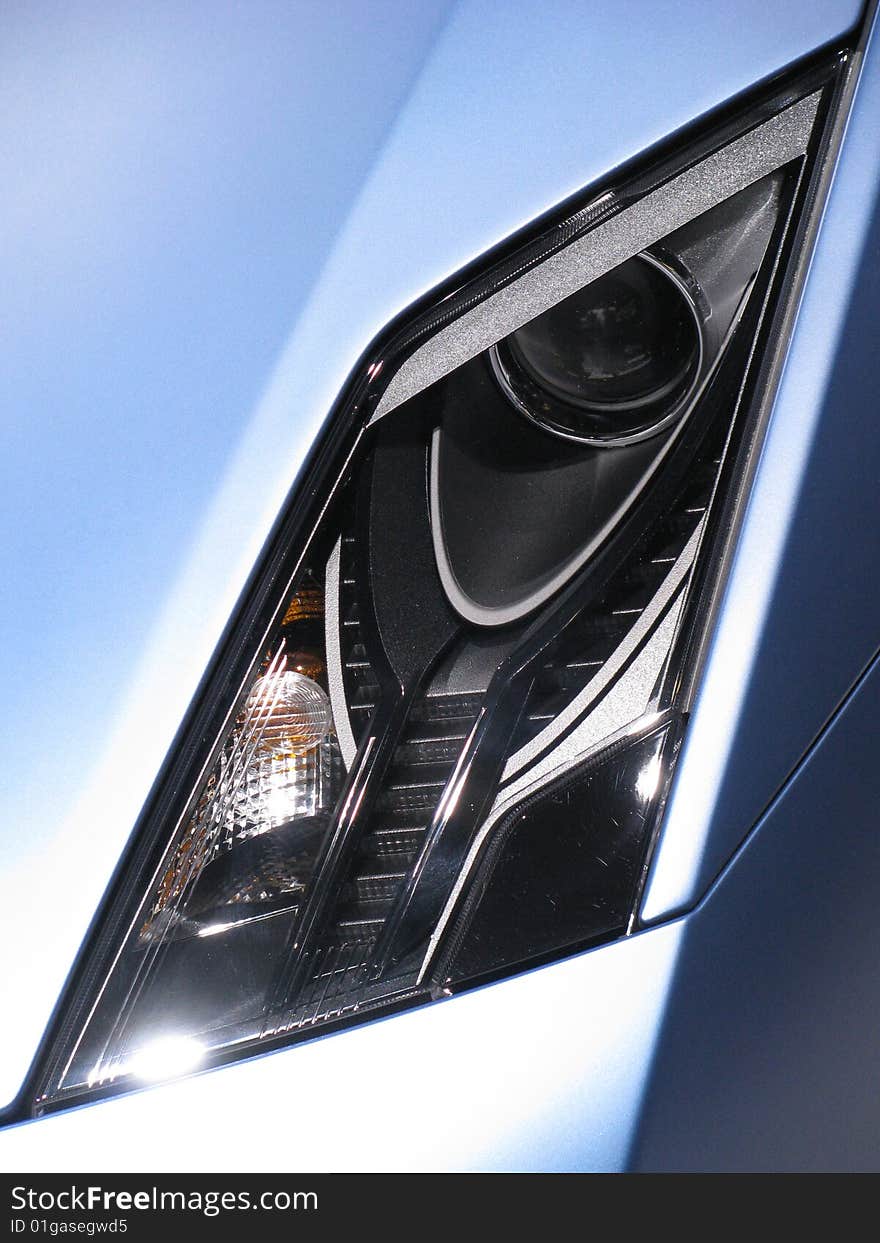 The headlight of a blue Lamborgini automobile, symbol of all that is class and sophistication. The headlight of a blue Lamborgini automobile, symbol of all that is class and sophistication.