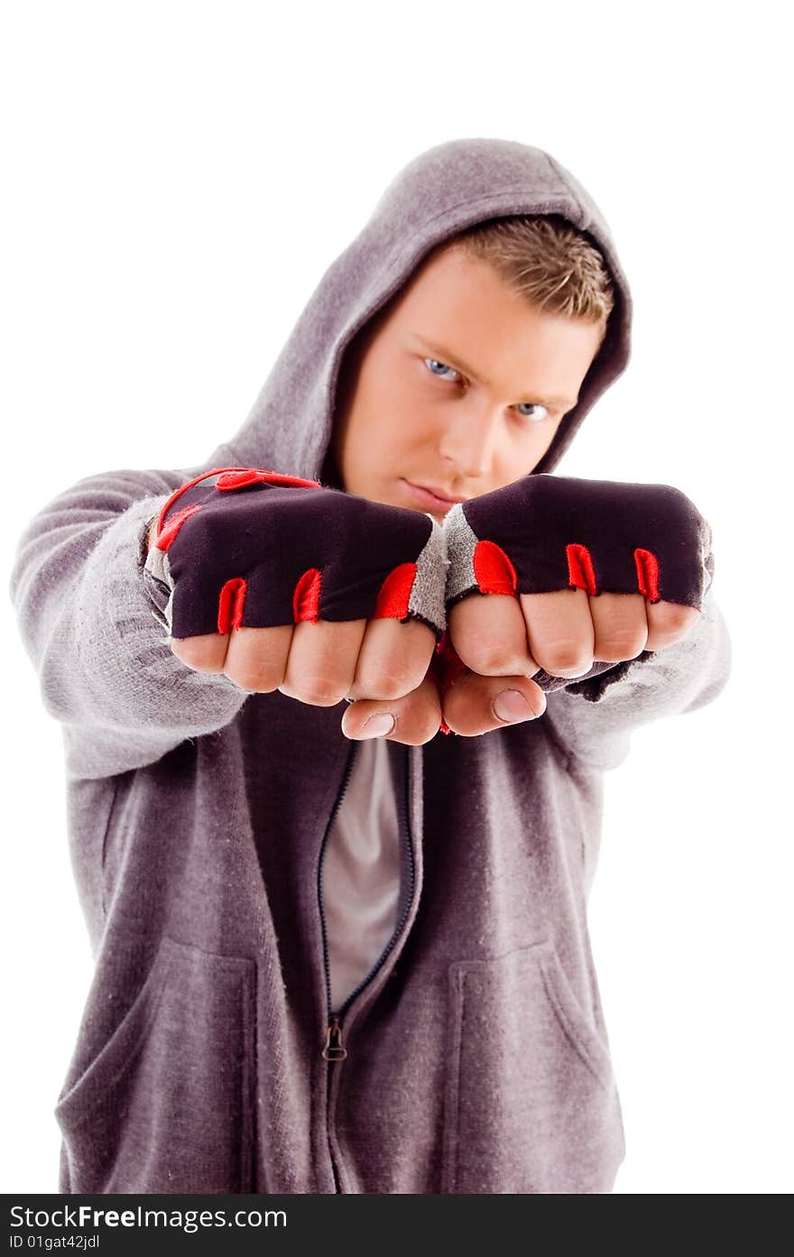 Young male showing fists against white background