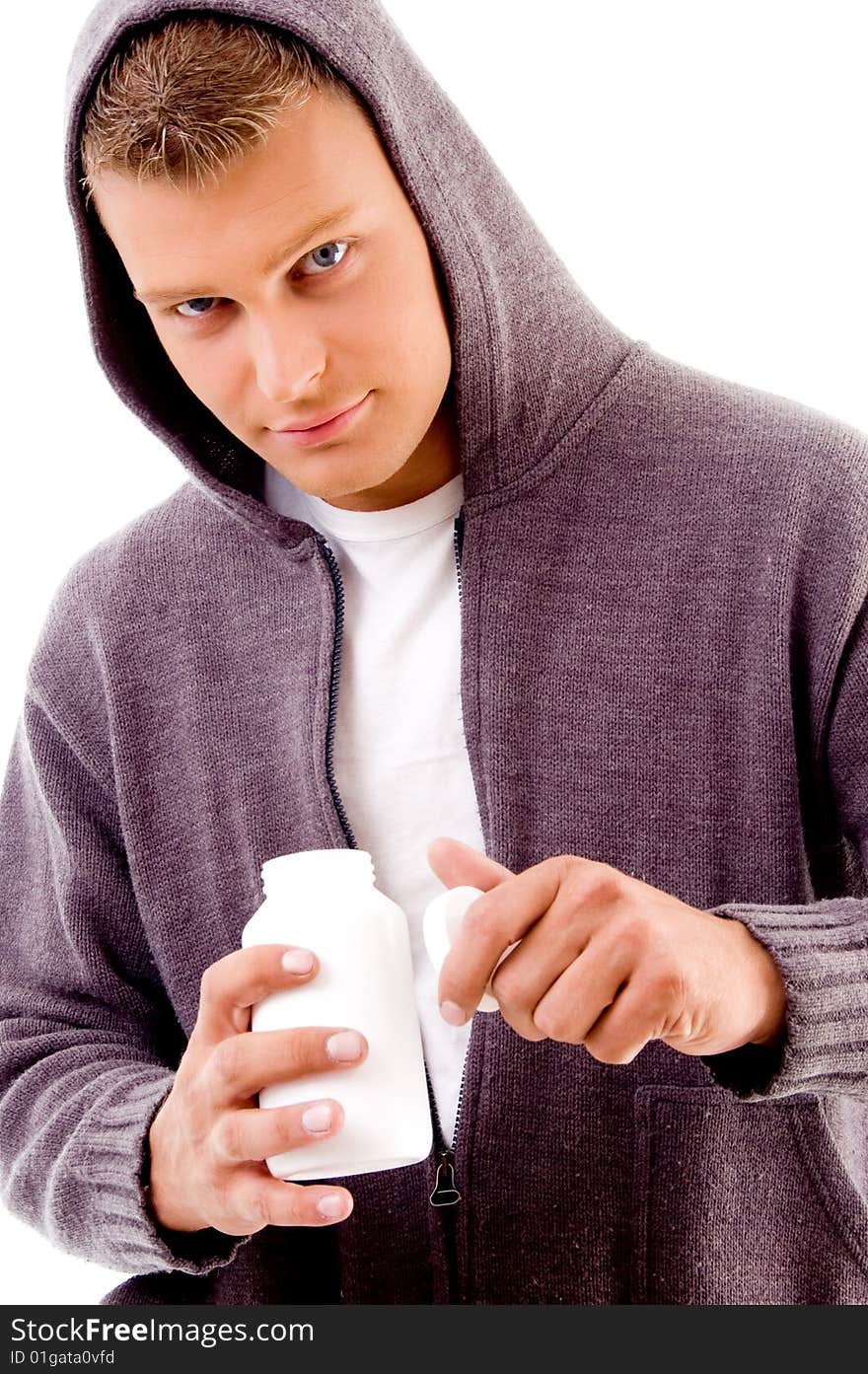 Young male holding medicine bottle with white background. Young male holding medicine bottle with white background