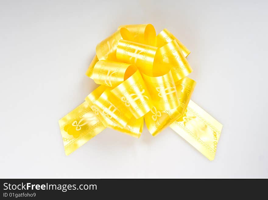 Yellow bow on a white background